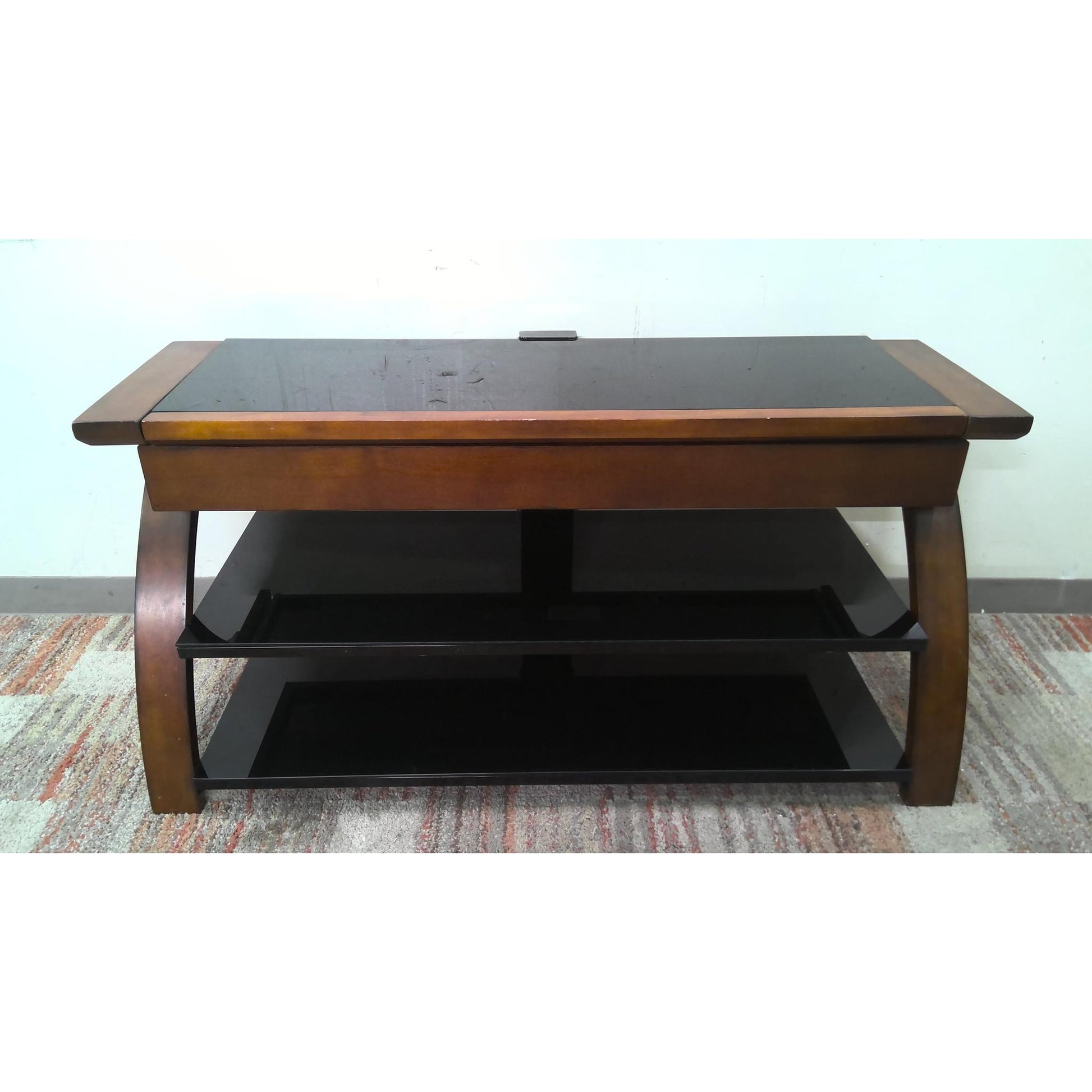 Wooden coffee table with a black glass top, front