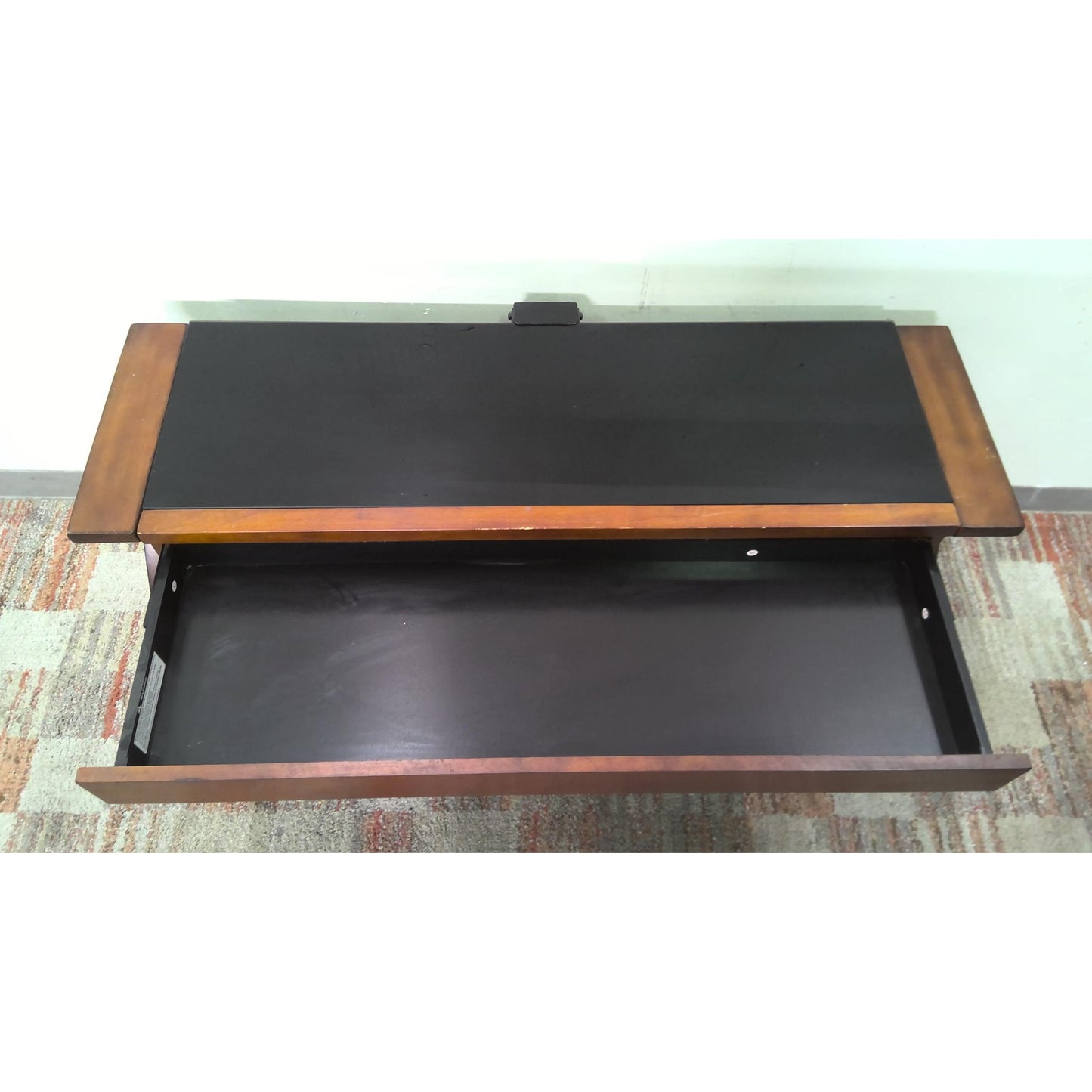 Wooden coffee table with a black glass top, above