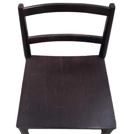 Aerial view of dark wooden chair with a plain background