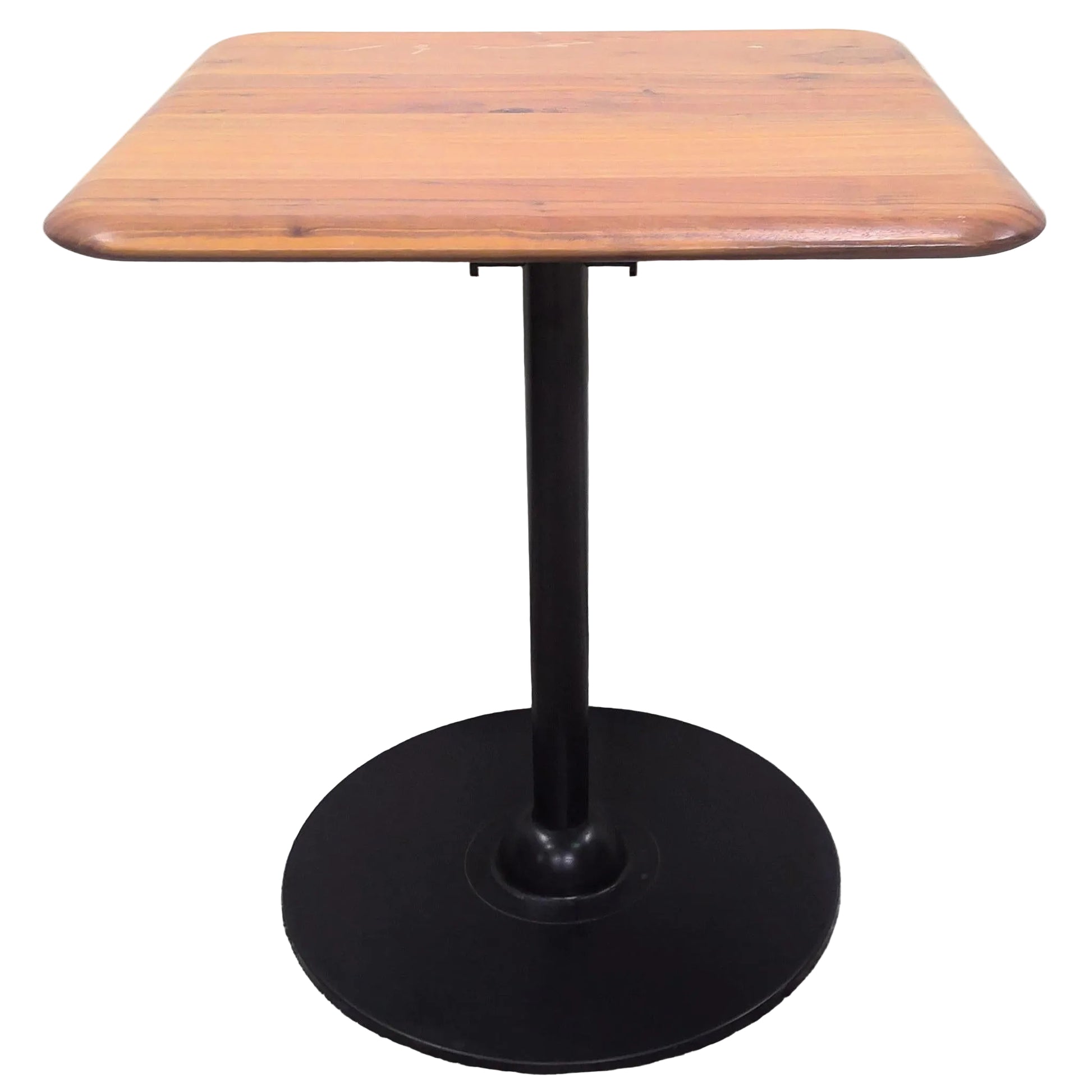 Wooden table with a black pedestal base.
