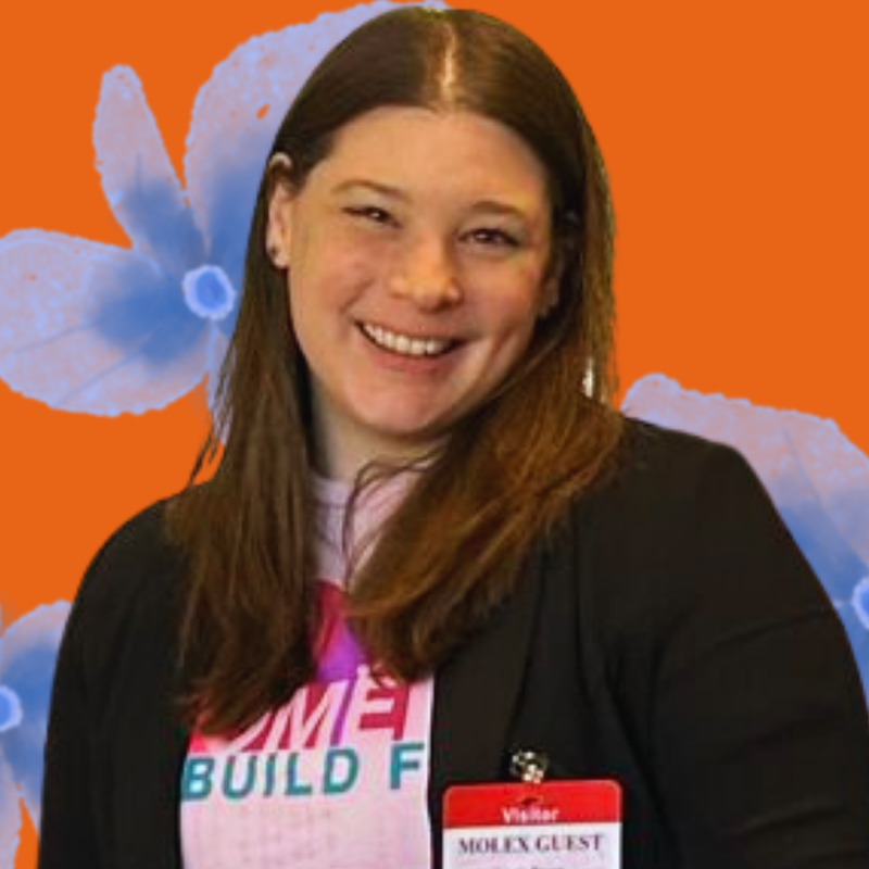 Person with a name tag against a blue and orange floral background